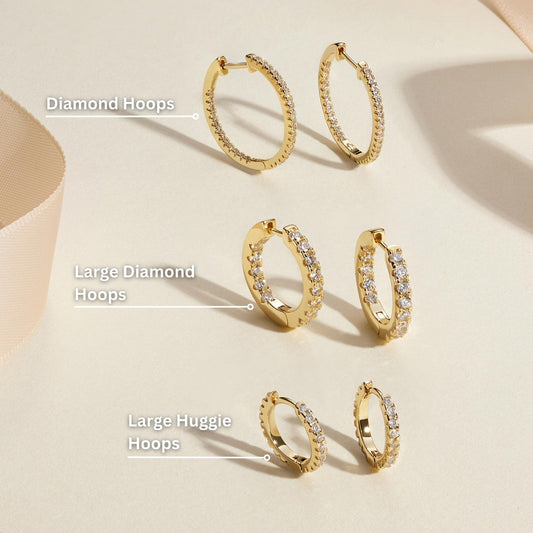 Gold diamond hoop earrings on display, assorted hoop sizes
