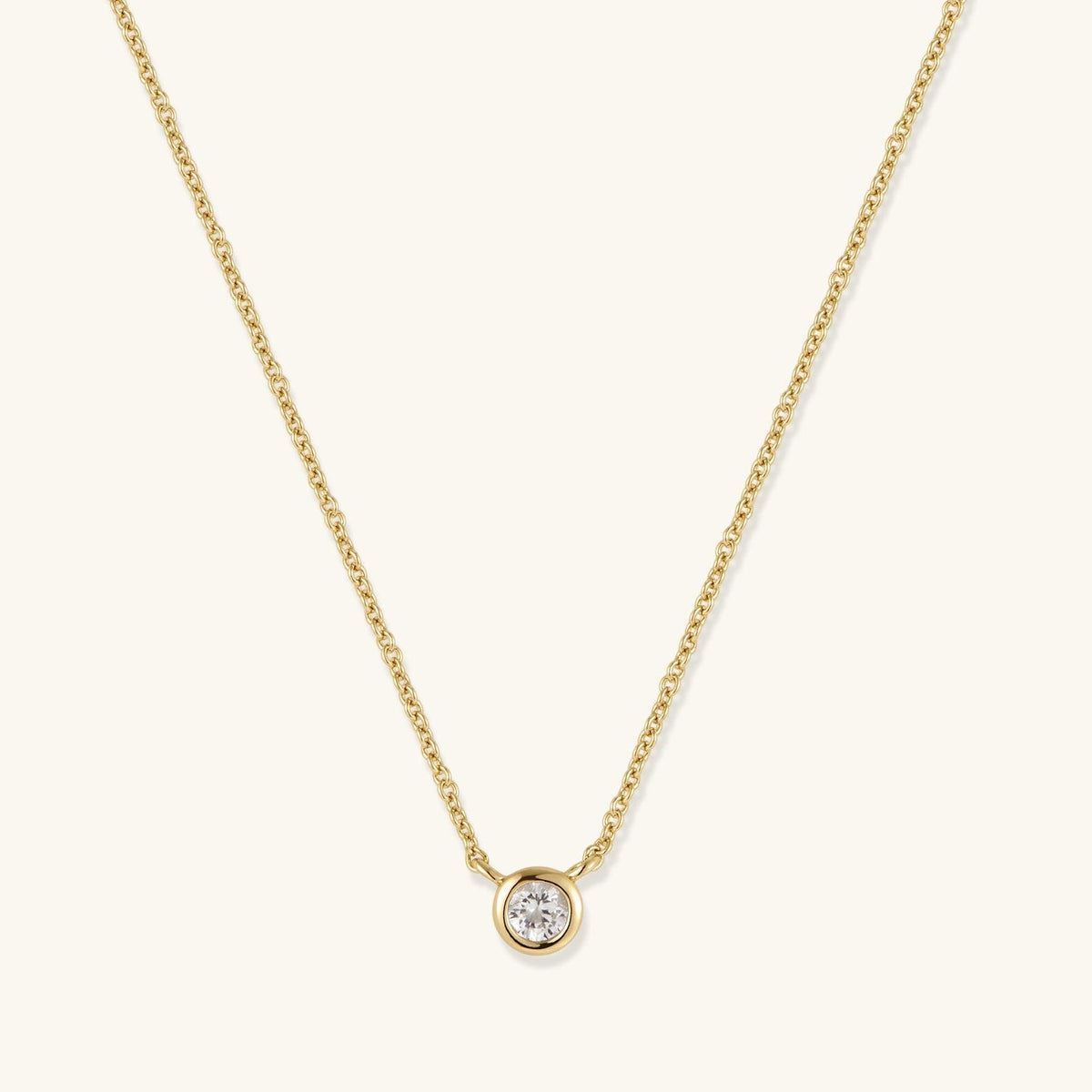 Gold-tone chain necklace with round bezel-set diamond pendant