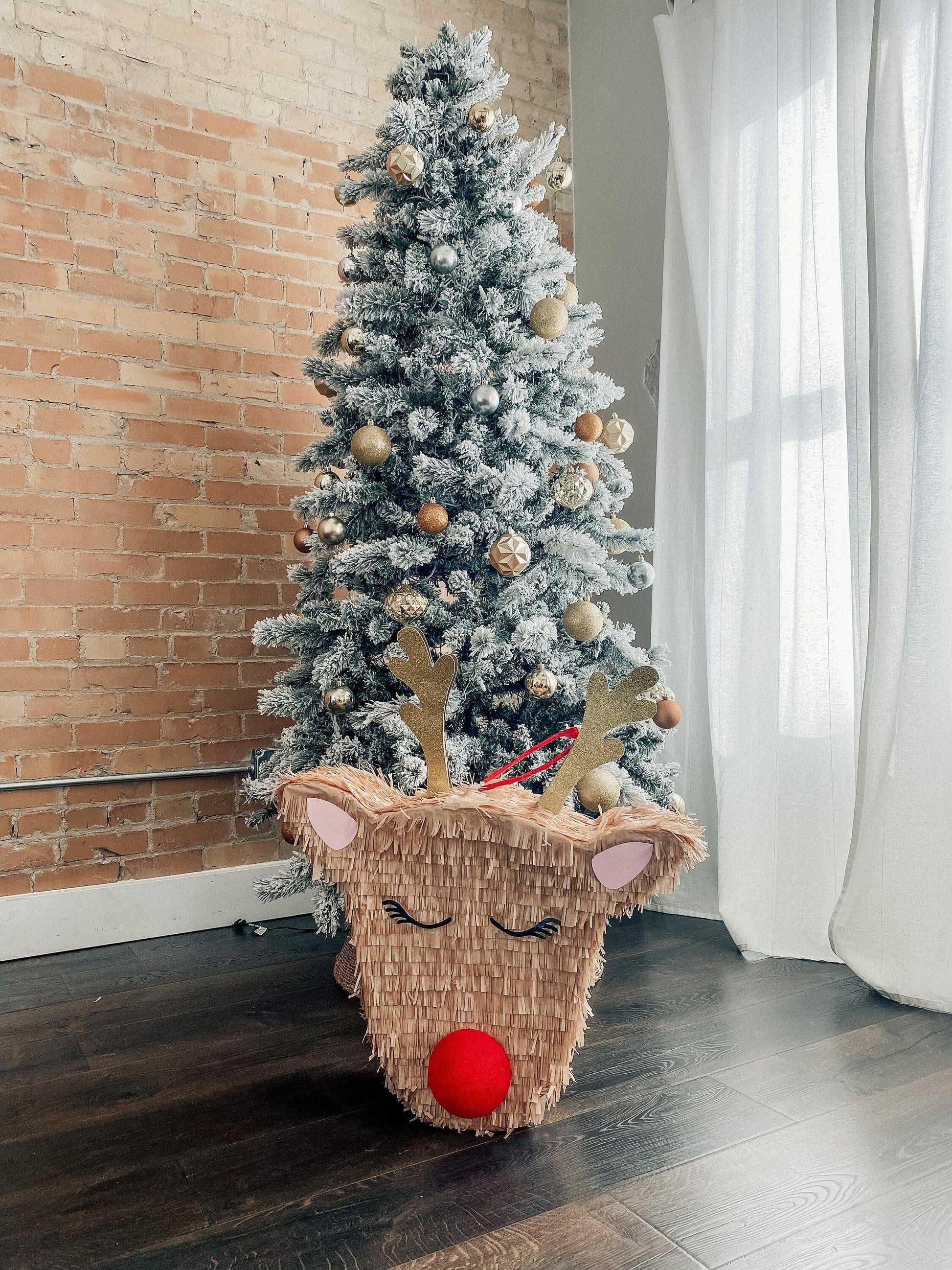 Rudolph reindeer piñata candy holder with fringe, antlers, closed eyes and red nose