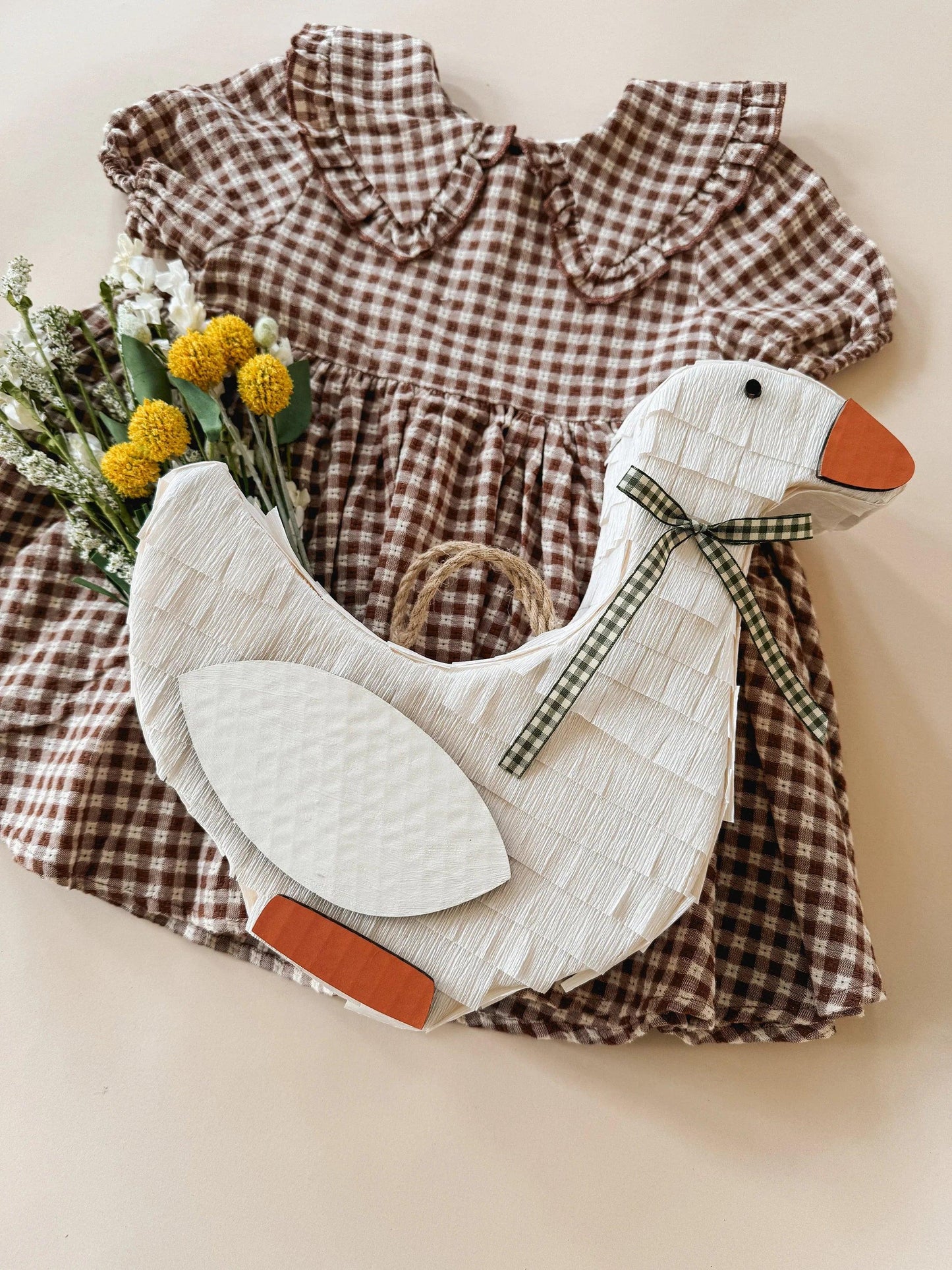White goose piñata with plaid bow and oval wing fabric panels