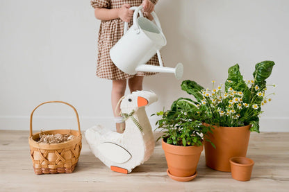 White goose piñata with green plaid bow and orange beak