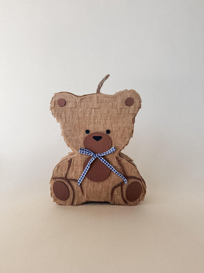 Teddy bear piñata side view, tan layered panels, loop handle, blue checkered neck tie