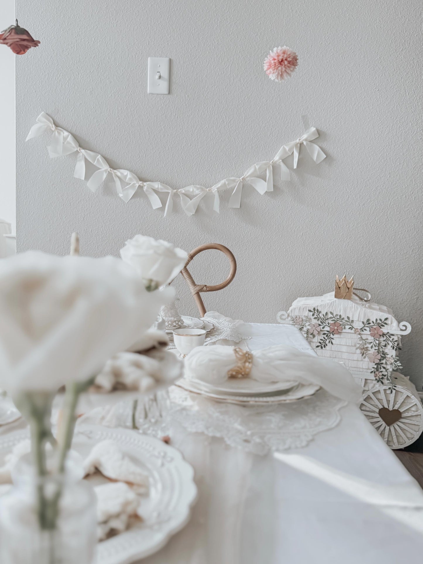 White princess carriage piñata with crown and floral wreath detailing