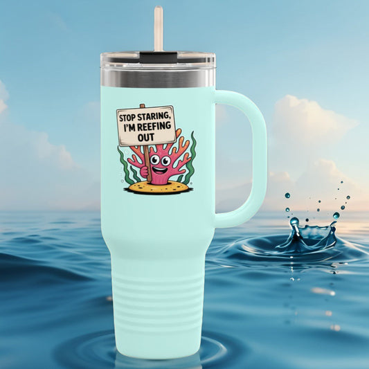 Insulated travel mug in light teal with coral reef cartoon graphic and straw lid