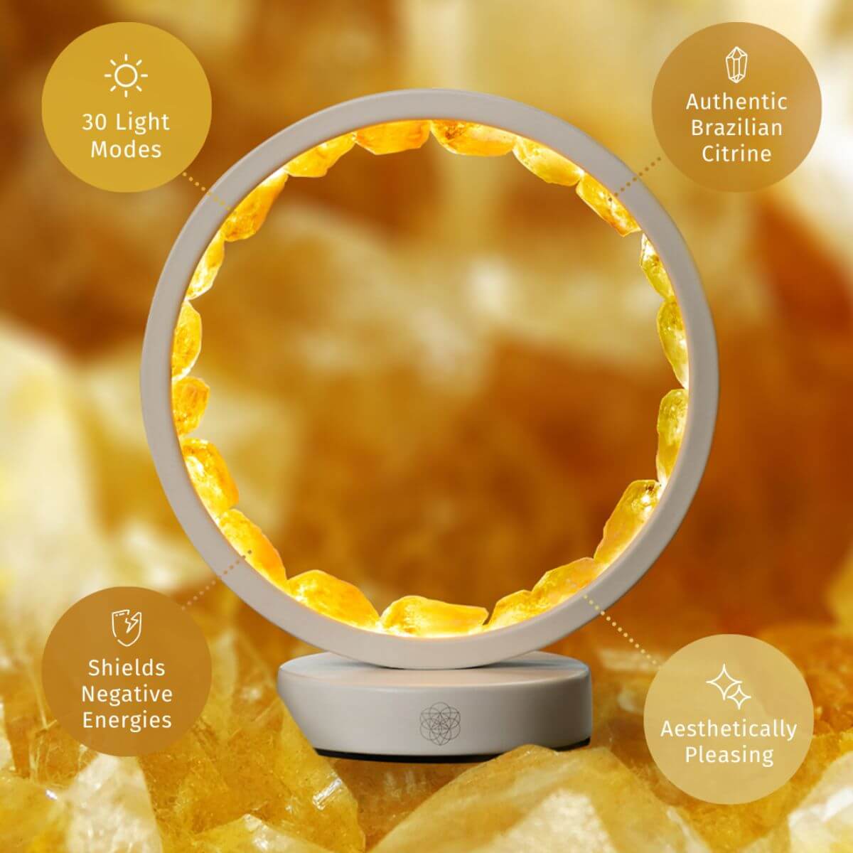 Citrine manifestation lamp with glowing gold ring on a white circular base