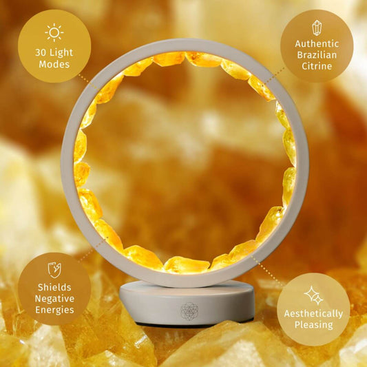 Citrine manifestation lamp with glowing gold ring on a white circular base