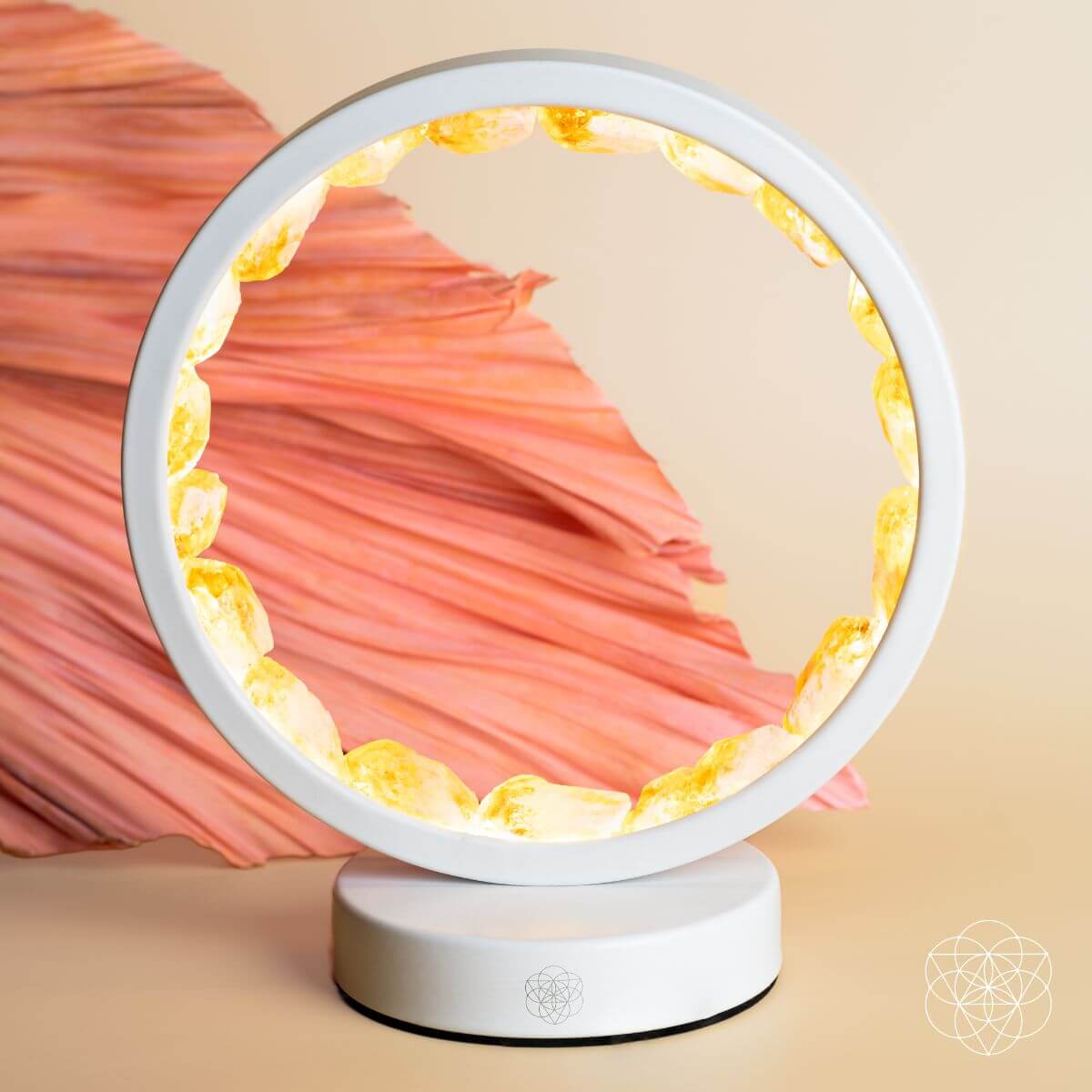 Citrine manifestation lamp glowing amber-gold ring with orange fabric behind