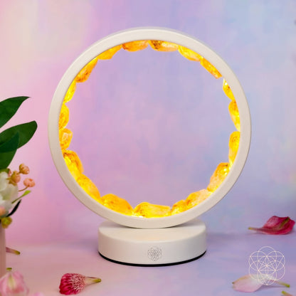 Citrine manifestation lamp with glowing gold ring and white stand
