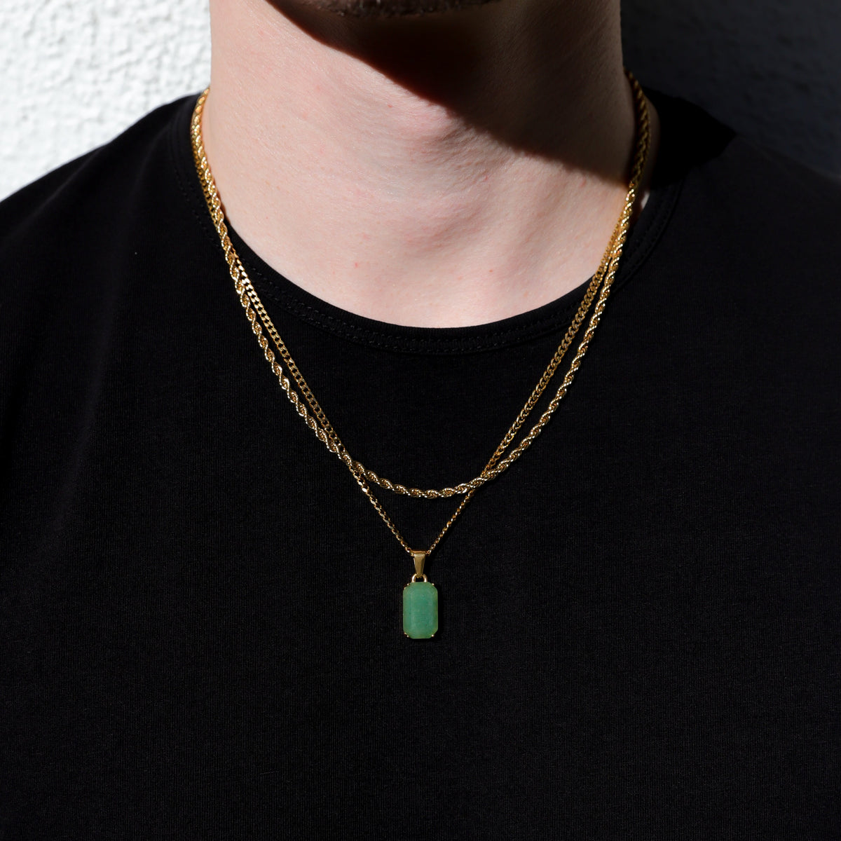 Gold-tone double-chain necklace with green rectangular stone pendant
