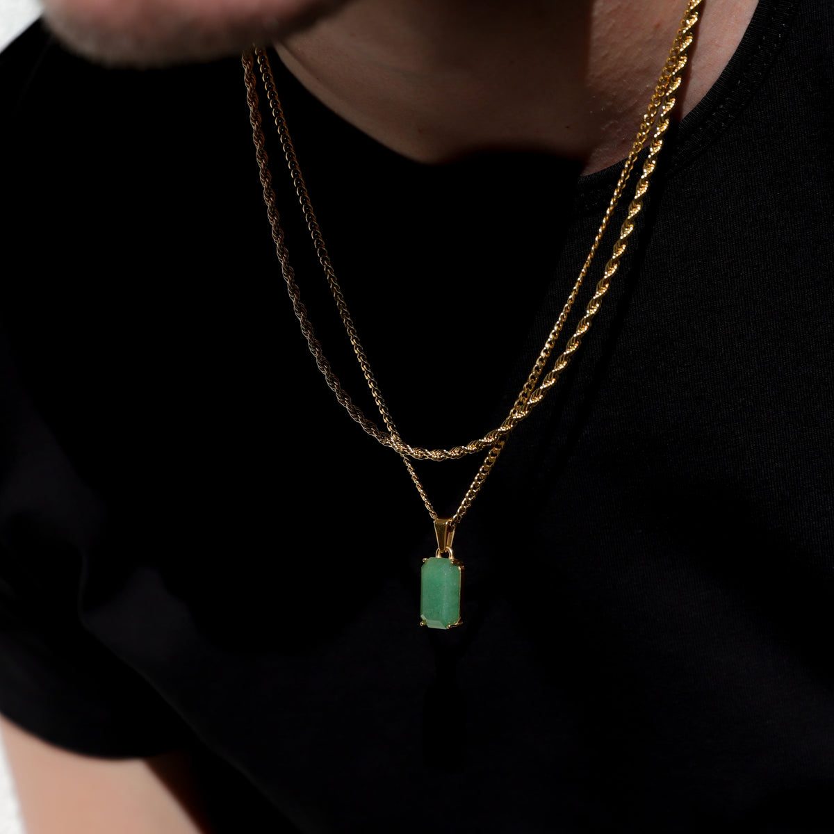 Gold-tone layered chain necklace with square green stone pendant