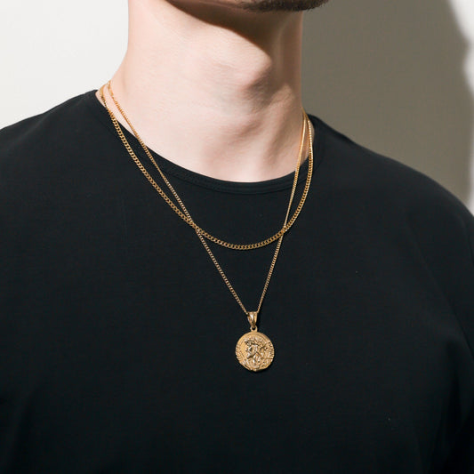 Gold-tone round Jesus medallion pendant on a Cuban link chain necklace