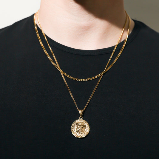 Gold-tone Jesus pendant on a Cuban chain necklace, round medallion style