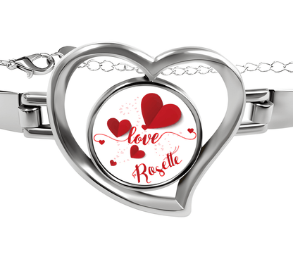 Heart charm bracelet with silver heart locket reading "Love Rosette" and red hearts