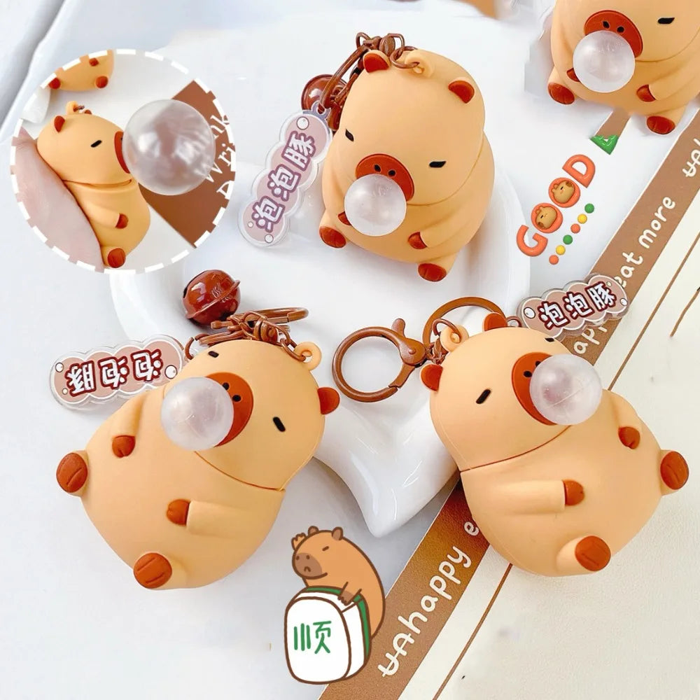 Capybara squeeze toy keychain with bubble top, brown-orange plush face and rings
