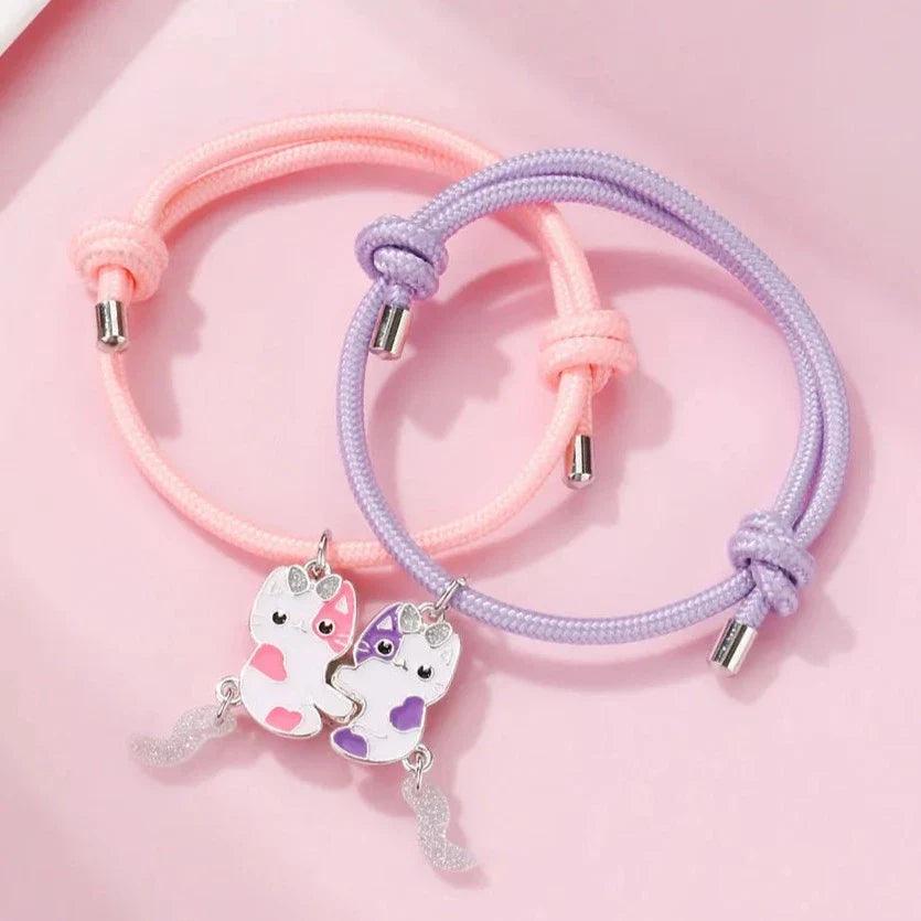 Pink and purple braided friendship bracelets with two cat charms and silver clasp beads