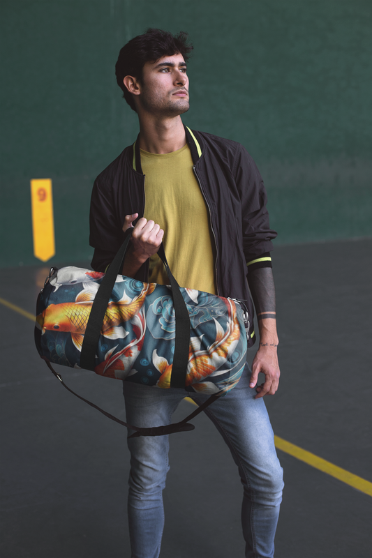 Koi print duffel bag worn crossbody with black shoulder strap