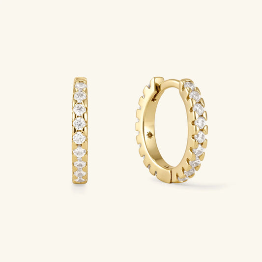 Gold-tone pavé hoop earrings set with round clear stones