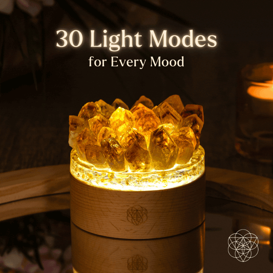 Glowing citrine crystal lamp with faceted crystal top on a wooden base