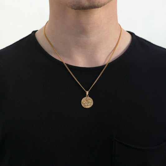 Gold lion medallion pendant necklace on an adult, showing short neckline drape.