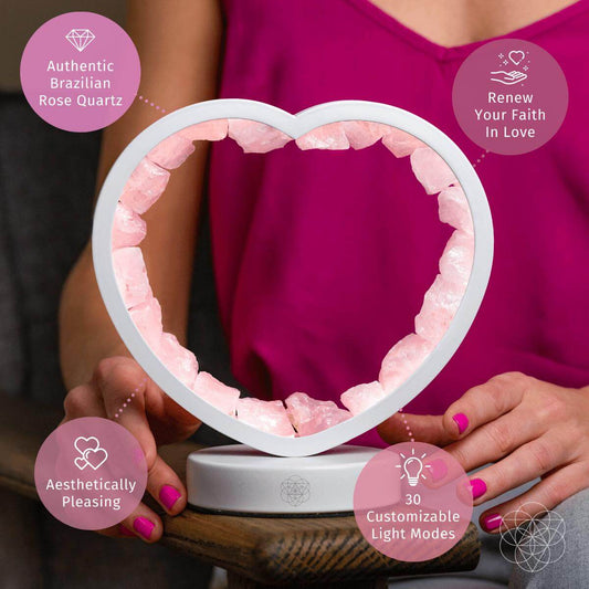 Heart-shaped rose quartz lamp with crystal inlay and gray base.