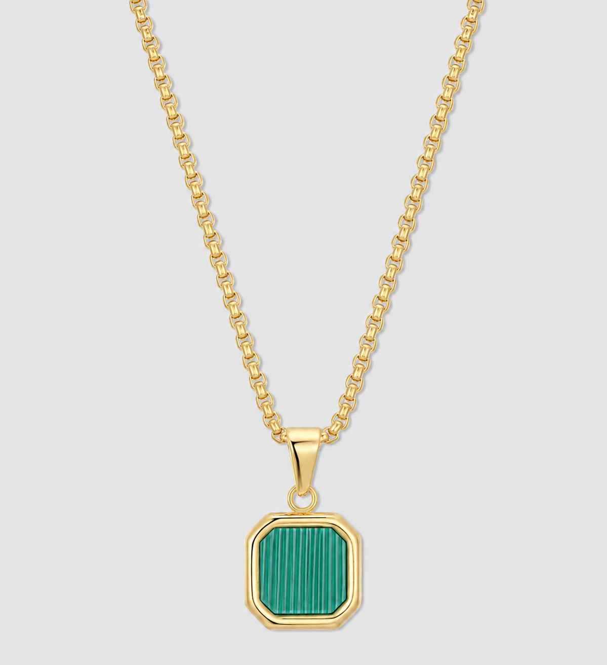 Gold chain necklace with green square pendant set in a gold bezel