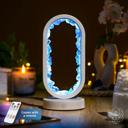 Clear quartz achievement lamp with glowing blue oval centerpiece on white base