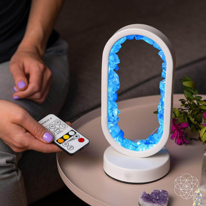 Clear quartz achievement lamp with glowing blue oval frame and handheld remote
