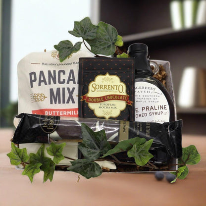 Breakfast gift basket with pancake mix, double chocolate mocha mix, maple syrup, and greens