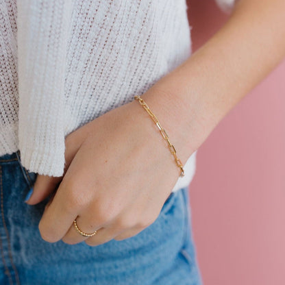 Gold-filled paperclip bracelet shown close up on the wrist.