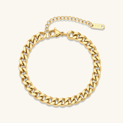 Gold curb chain bracelet with wider links and oval clasp tag marked K18D.
