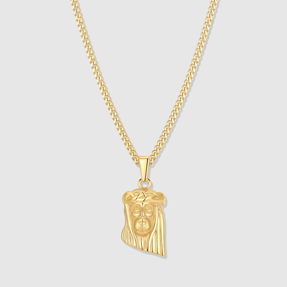 Gold Jesus charm pendant on a linked chain necklace