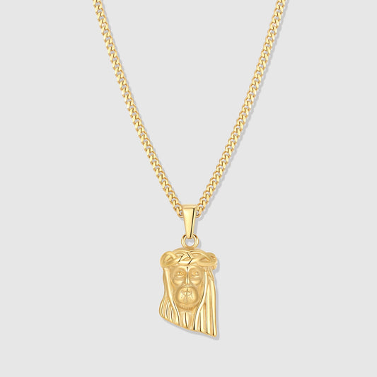 Gold Jesus charm pendant on a linked chain necklace