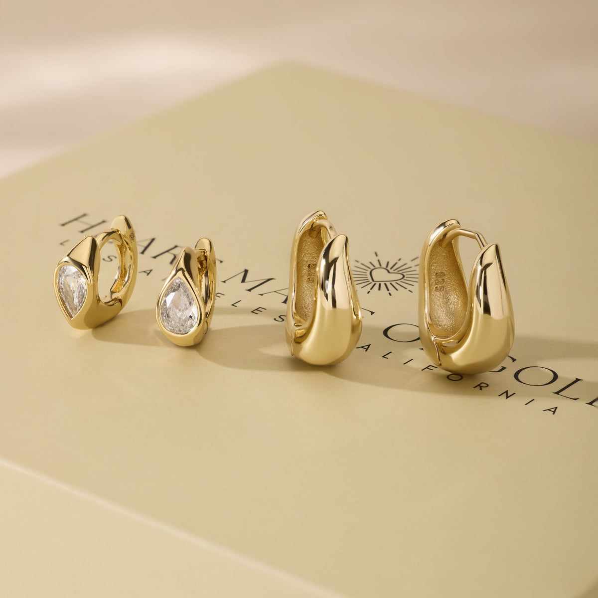 Gold-tone wavy hoop earring set with clear stones and smooth hoops