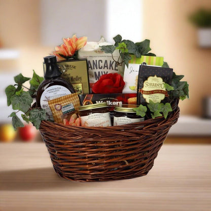 Wicker breakfast gift basket with pancake mix, syrup, jam jars, and chocolate bars