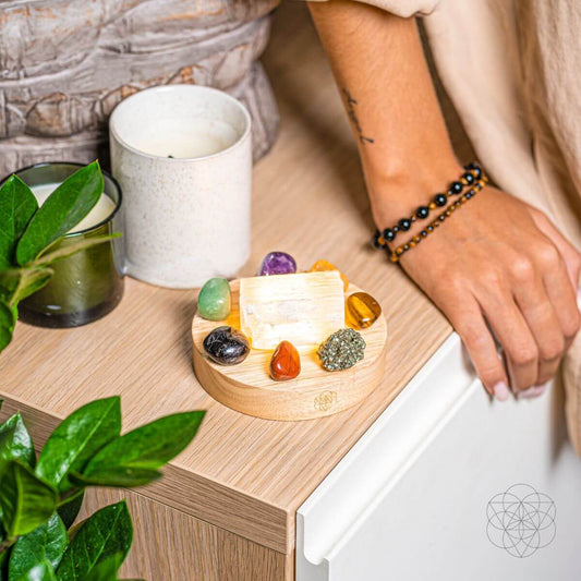 Crystal decor on a round wooden base with gemstones and a clear central crystal