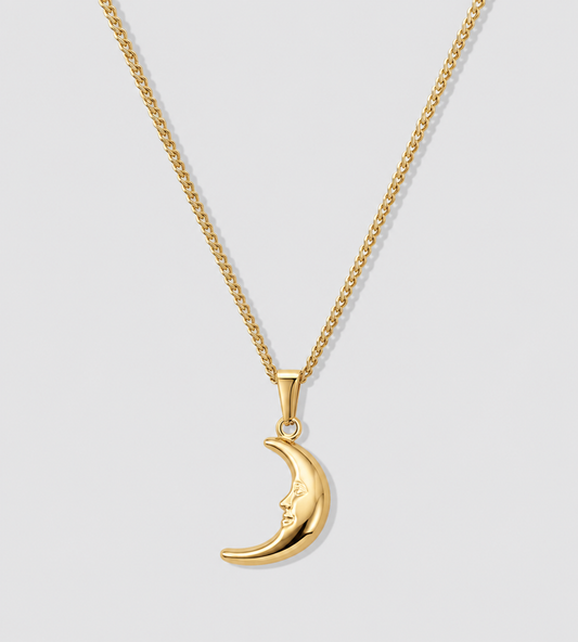 Gold crescent moon pendant on a chain, with a small round bail at the top.
