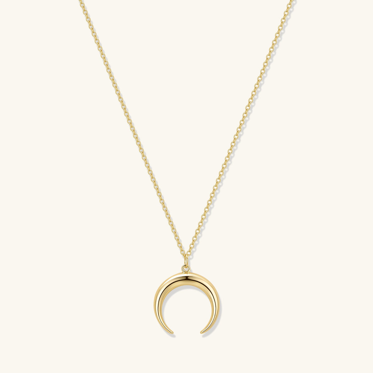Gold crescent moon pendant necklace with long chain and subtle link detail