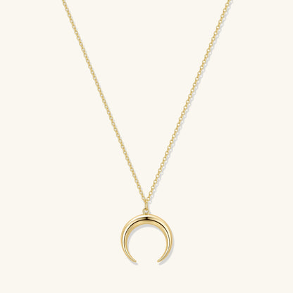 Gold crescent moon pendant necklace with long chain and subtle link detail