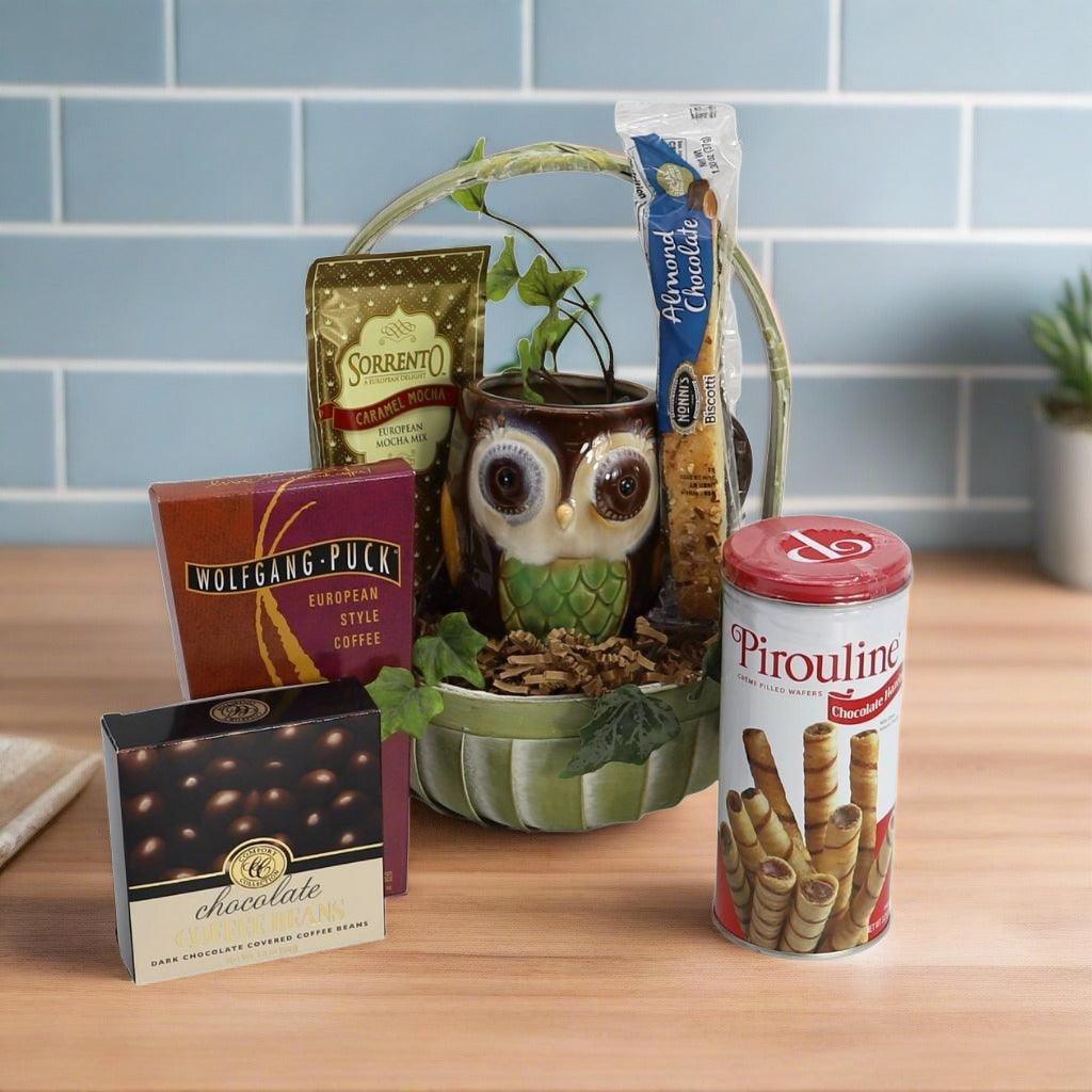 Gift basket with owl container, coffee and chocolate boxes, and wafer rolls canister