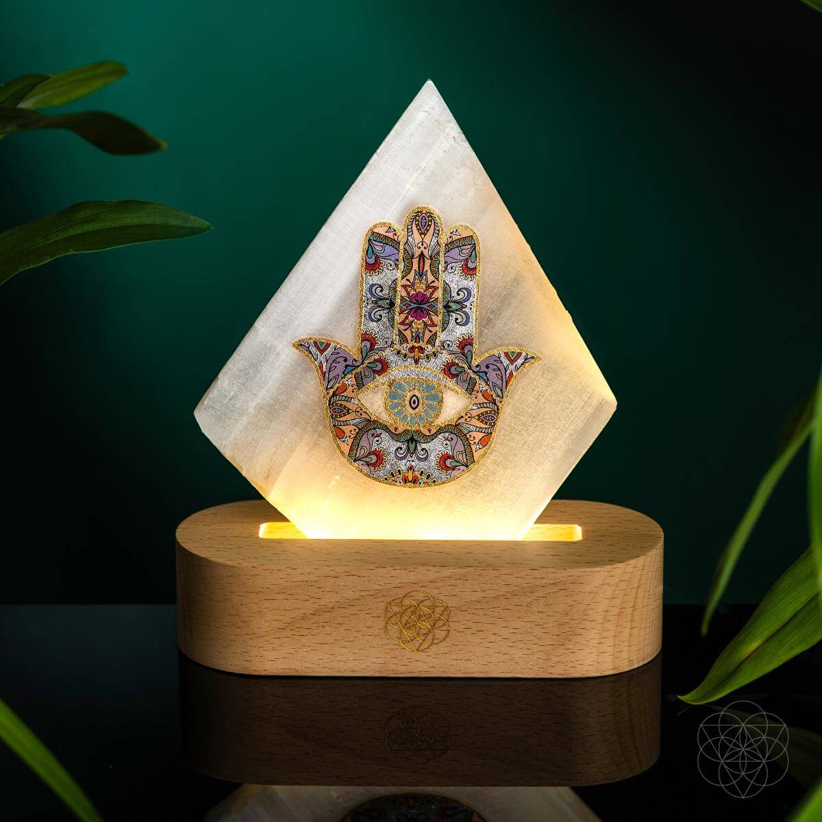 Glowing pyramid mood lamp with Hamsa print on round wooden base