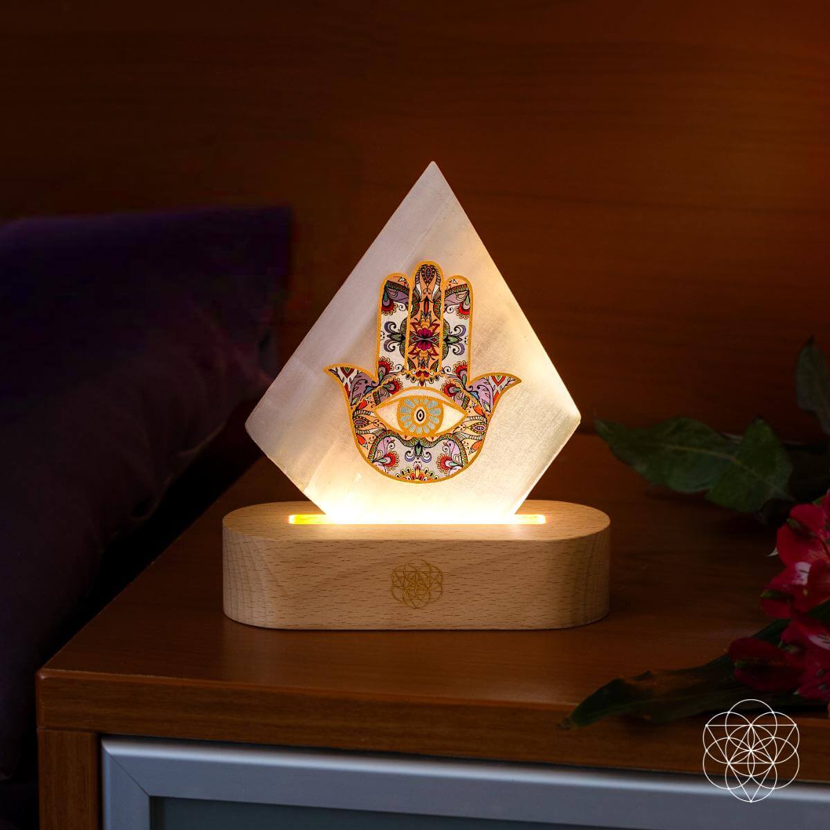 Glowing pyramid mood lamp with Hamsa print on round wooden base