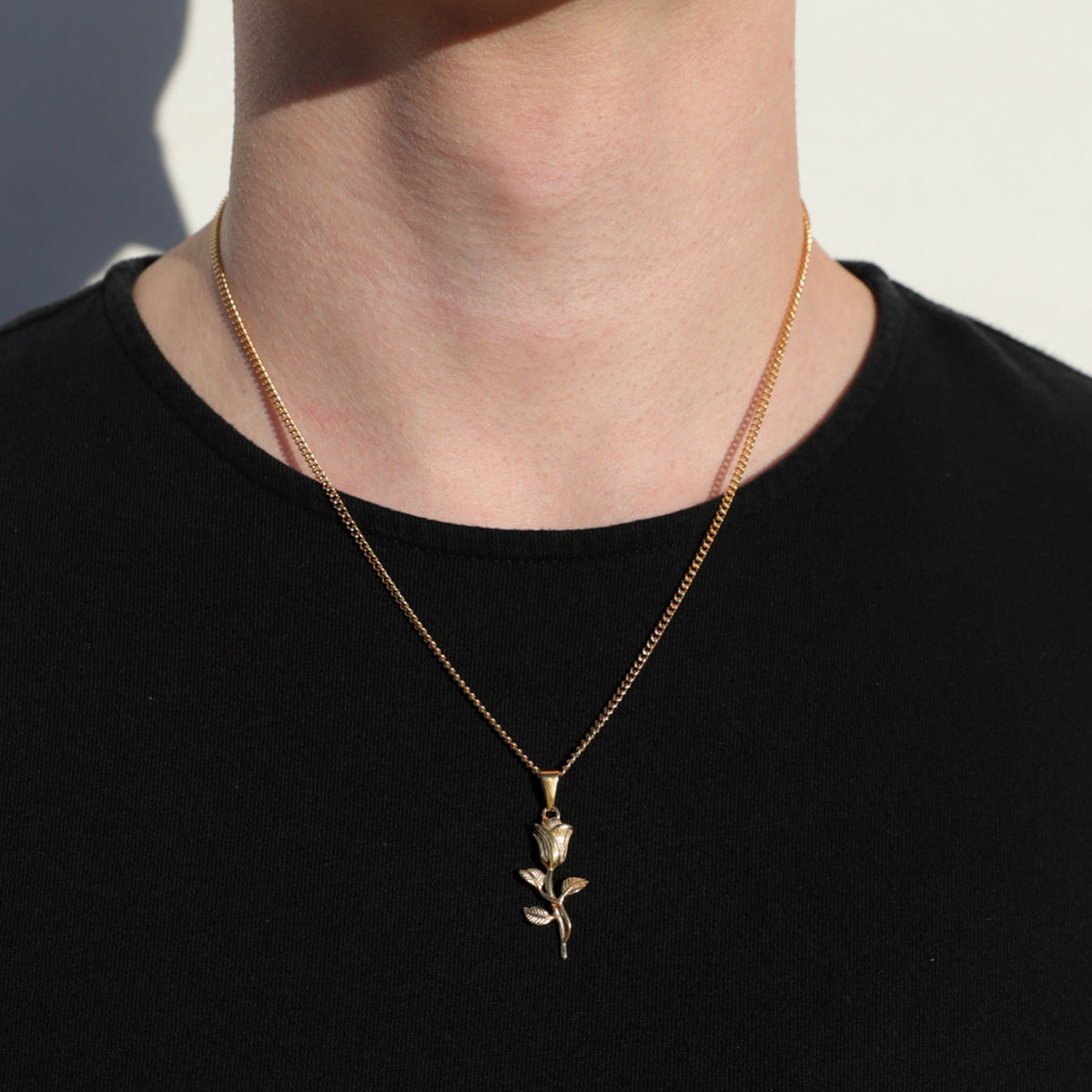 Gold rose pendant necklace on a rope chain