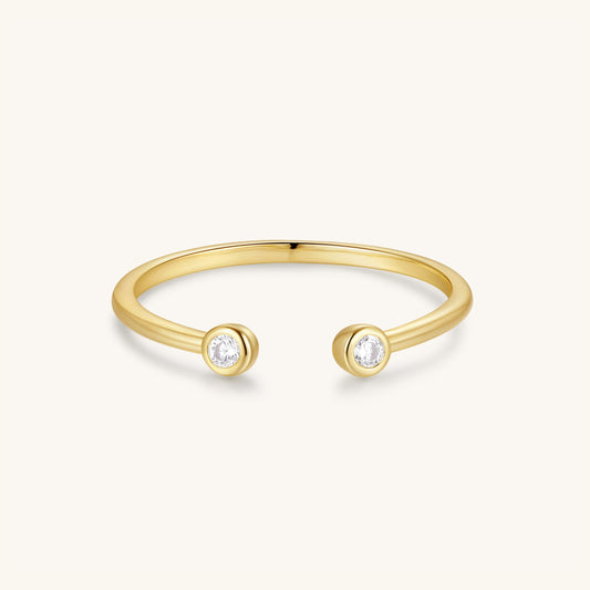Open bezel ring, gold-tone band with two round bezel-set stones