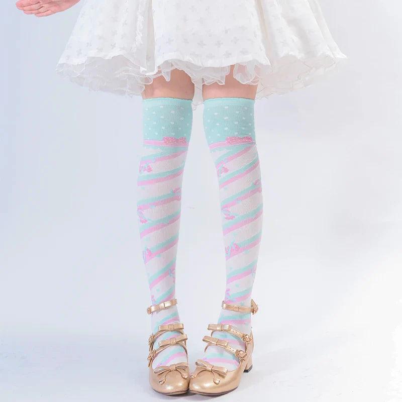 Knee-high socks in light mint with pastel rainbow stripes and tiny heart pattern