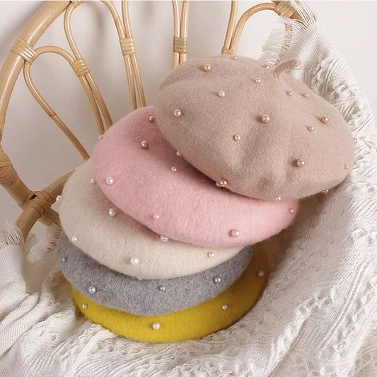 Pink felt beret with faux pearl embellishments, teardrop crown shape and short brim