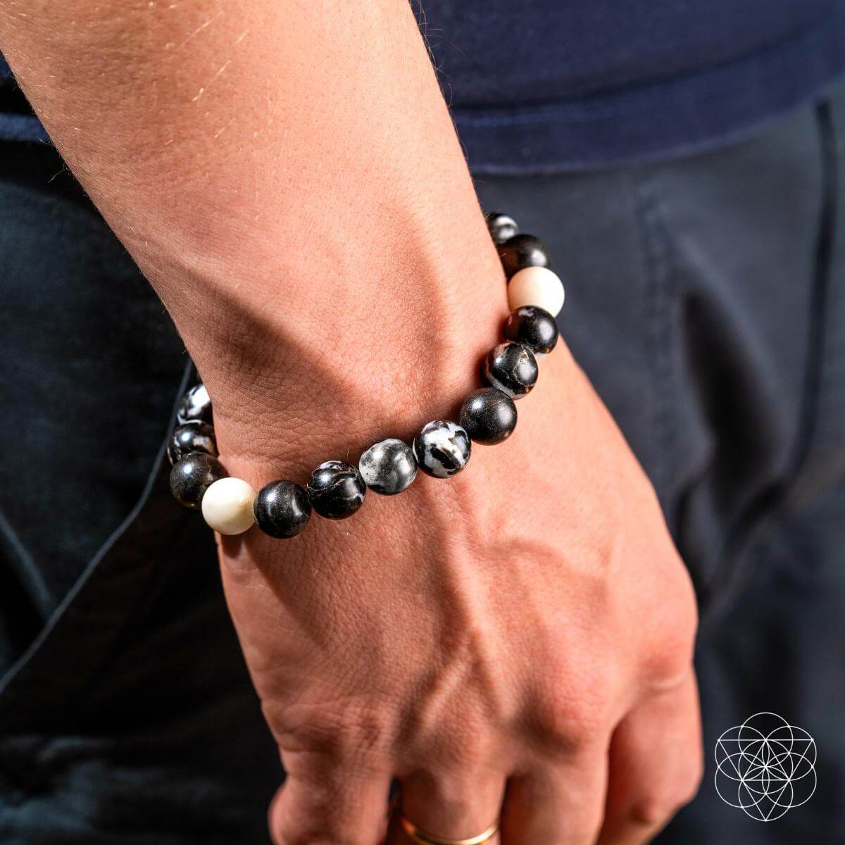 Zebra jasper bead bracelet with black, white, and marbled stones on wrist