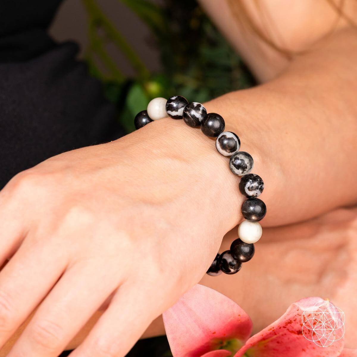 Beaded zebra jasper bracelet on wrist, black and white round stones