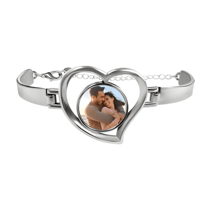 Heart-shaped photo bracelet with silver-tone frame and clasp, featuring a couple photo