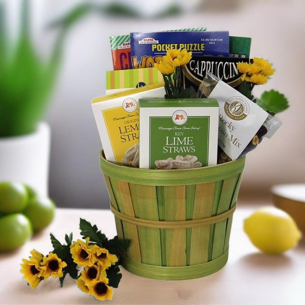 Gift basket with green bamboo-style container and yellow flowers, filled with packaged snacks