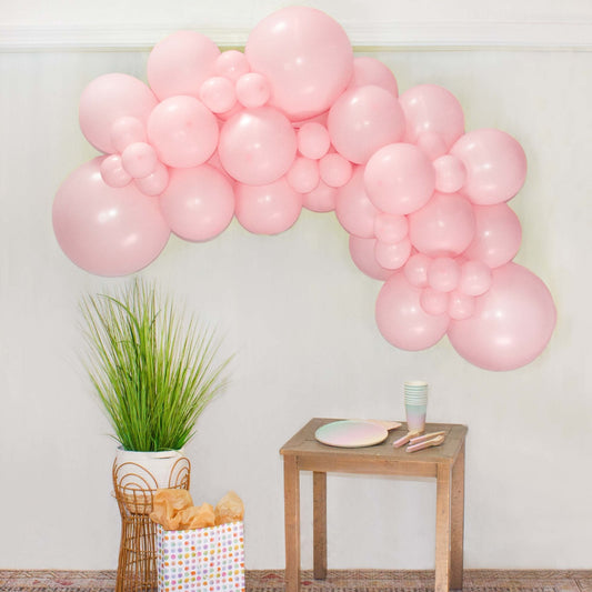 Pink balloon garland arch with glossy pastel balloons for party decoration